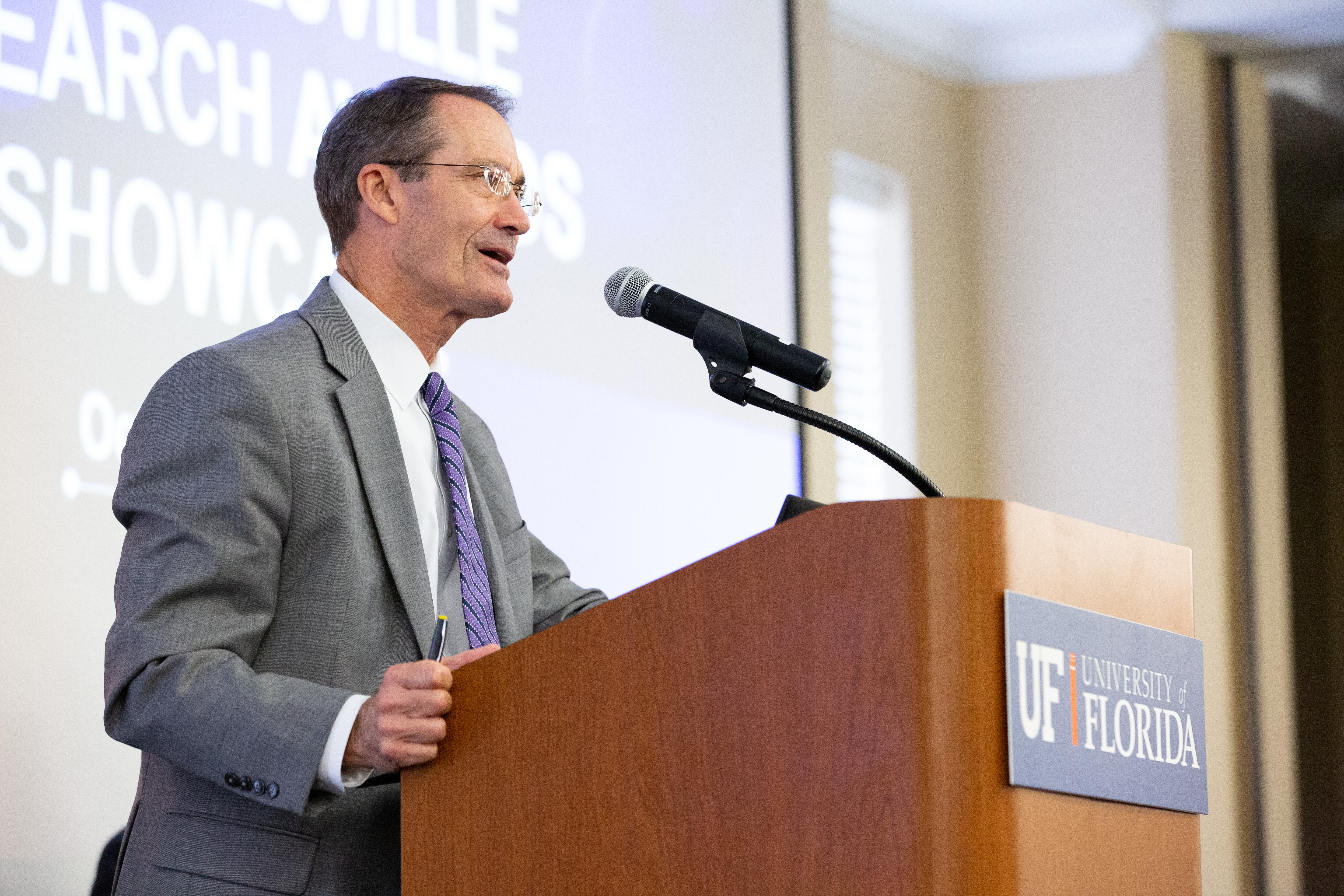 dr. charlie lane speaking at podium