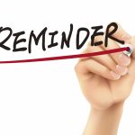 hand writing and underlining the word reminder