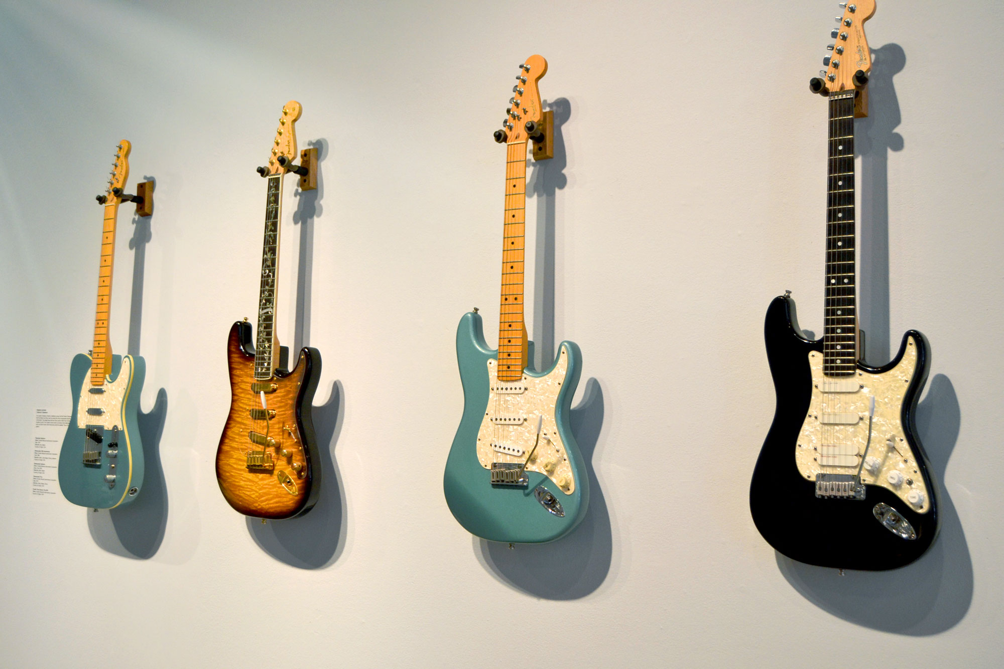 Image of guitars hanging on a gallery wall