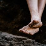 Photo of bare feet with dirt
