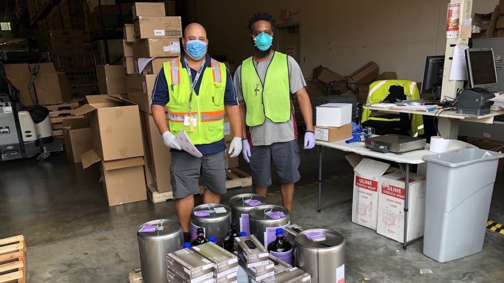 UF Health Warehouse workers receive hand sanitizer from UF Chemistry