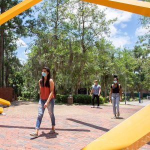 Students wearing masks while walking through campus