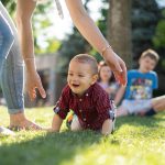 Small child crawling in grass