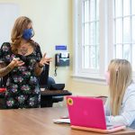 Student and professor wearing masks