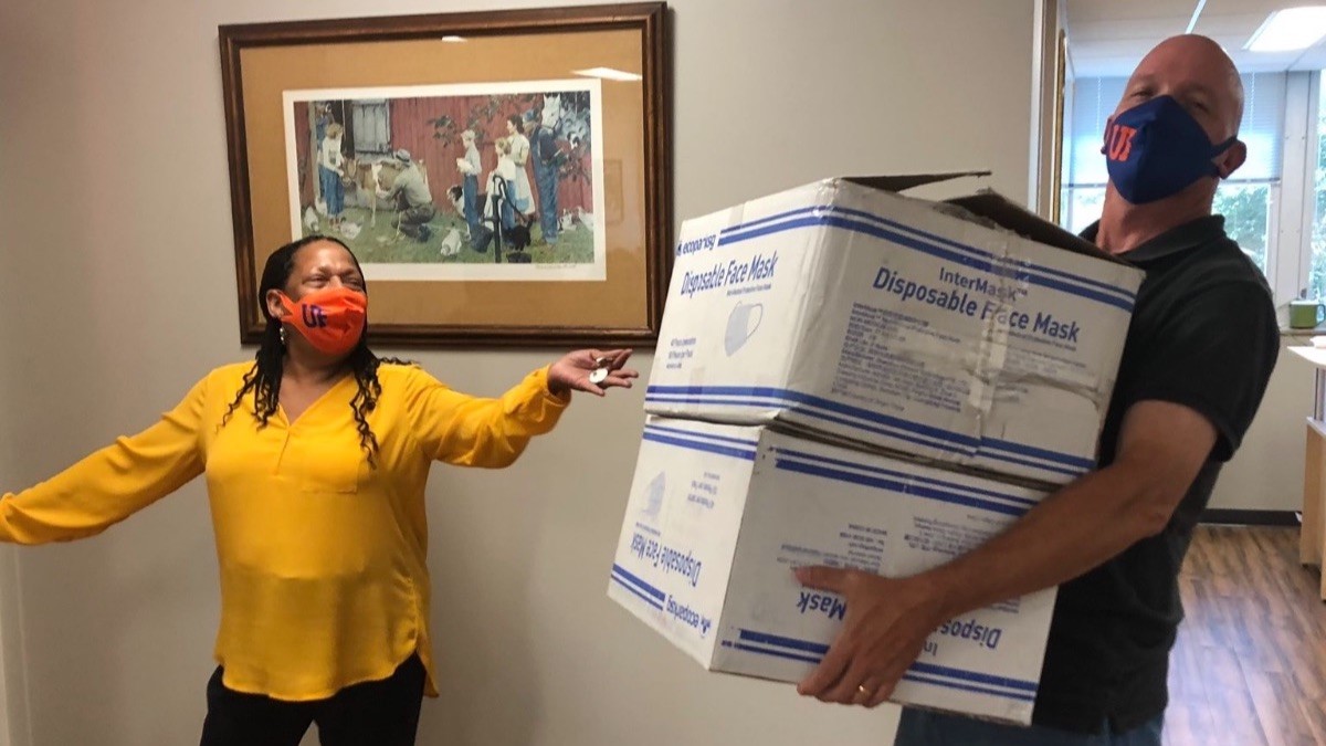 Randy Edwards of the School of Forest Resources collects supplies from UF IFAS Executive Assistant Goldie King