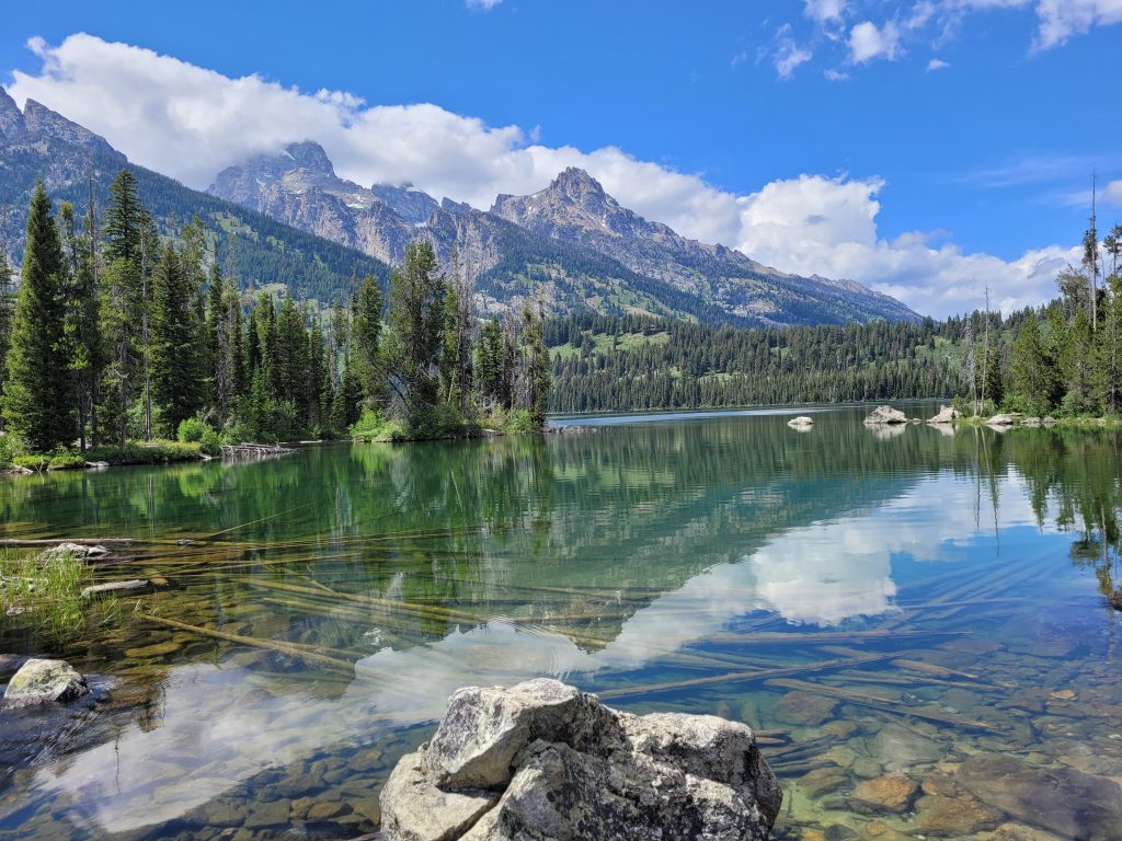 An image of the lake with mountains in the background taken at Grand Teton National Park.